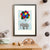 A grey elephant tied to a bunch of colourful balloons flies high among the clouds (A3 framed with white mount)