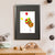 A furry brown sloth flies high while holding on to a bunch of red, yellow, and green balloons, though a couple of the balloons have escaped his grasp (A3 framed with black mount)