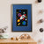 A grey bunny looks out of the window of a red, white and blue rocket, as it flies through space amongst colourful planets, stars and comets (A3 framed with blue mount)