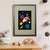A grey bunny looks out of the window of a red, white and blue rocket, as it flies through space amongst colourful planets, stars and comets (A3 framed with grey mount)