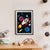 A grey bunny looks out of the window of a red, white and blue rocket, as it flies through space amongst colourful planets, stars and comets (A4 framed)